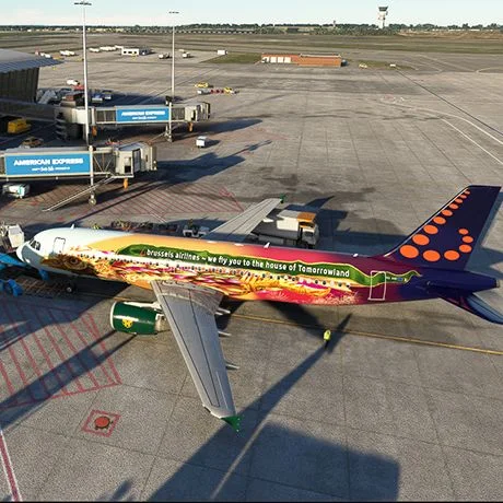 Aircraft with a colourful livery parked at an airport gate in a flight simulator.